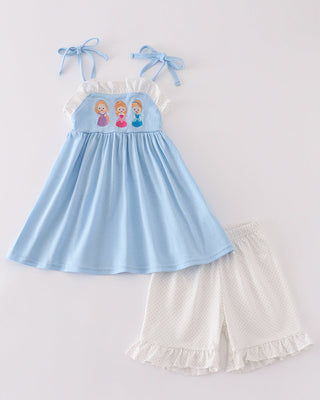 A blue princess embroidery ruffle girl shorts set with a top and shorts, featuring white embroidered princess figures on the top and a ruffled white hem on the shorts.