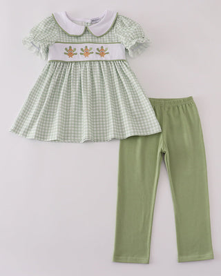 Green checkered dress with white collar and matching pants on a light gray background