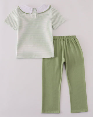 Striped shirt and green pants on a light gray background