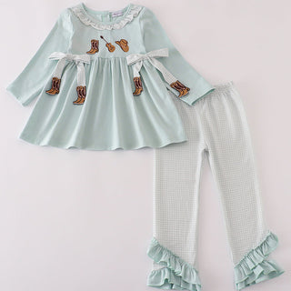 Children's outfit with light blue top and leggings on a white background