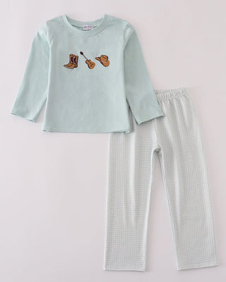 Children's pants set with light blue top and checkered pants on a white background