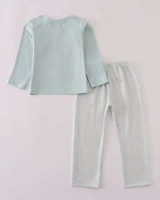 Light blue pants set with long-sleeve top and pants on a light gray background