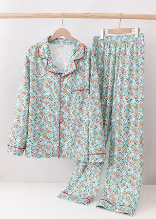 Christmas pajama set on a hanger against a white background