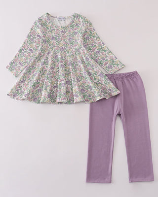 Floral top and purple leggings on a light gray background