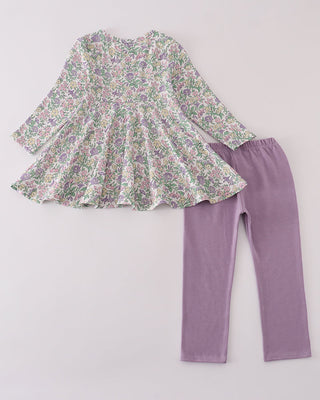 Floral top and purple leggings on a light gray background