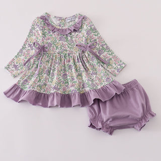 Floral top with ruffles and matching bloomers on a light gray background