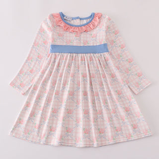 Floral dress with a blue waistband on a light gray background