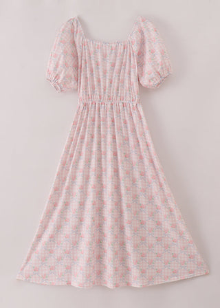 Pink floral dress with puff sleeves on a light gray background