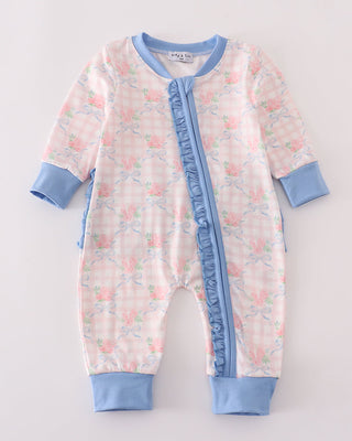Baby onesie with floral pattern and blue accents on a light gray background