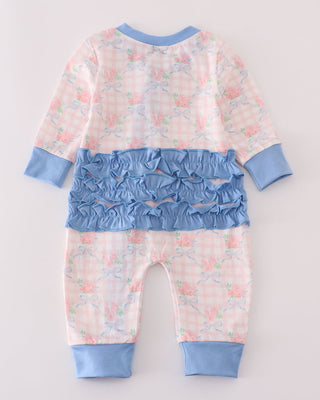 Baby romper with floral pattern and blue accents on a light gray background