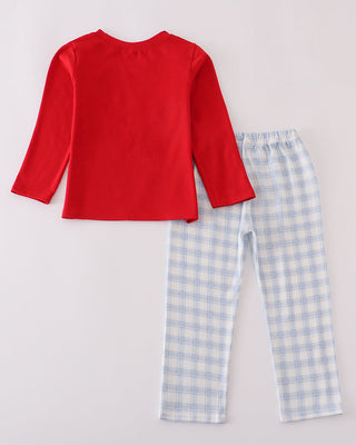 Red long-sleeve top and blue checkered pants on a light gray background