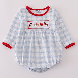 Blue checkered baby romper with red trim and farm-themed design on a light gray background