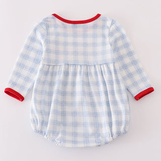 Blue and white checkered baby romper with red trim on a light gray background