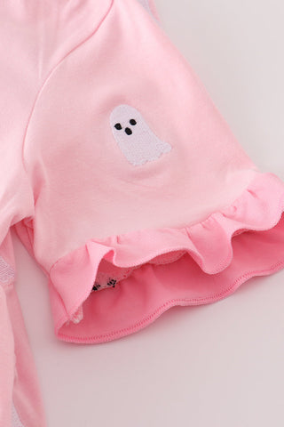Pink garment with ghost design on a light gray background