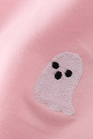 Embroidered ghost patch on a pink fabric background