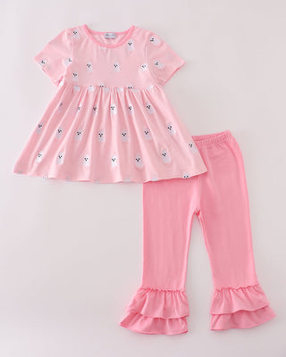 Pink children's dress and leggings set on a light gray background