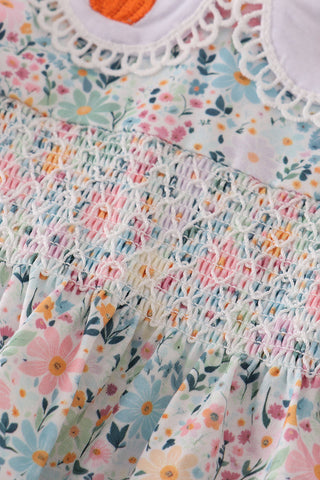 Close-up of a floral top with smocked details