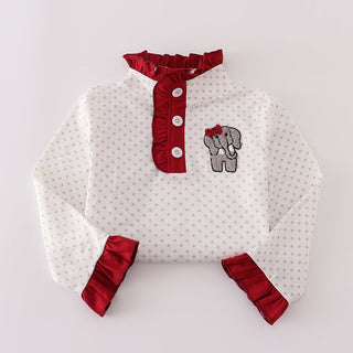 White  outfit with red accents and an embroidered elephant on a light gray background