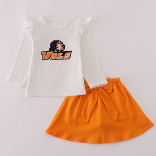 White top with 'VOLS' logo and orange skirt on a light gray background