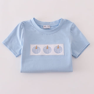 Light blue t-shirt with a graphic of three pumpkins on a light gray background