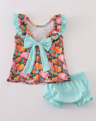 Baby outfit with pumpkin print top and matching bloomers on a light background