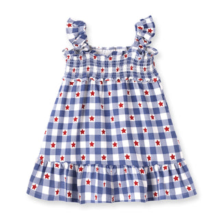 Children's dress with blue and white check pattern and red stars on a white background