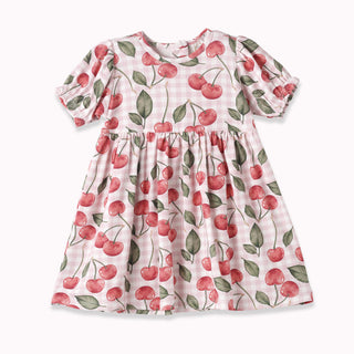 Children's dress with cherry pattern on a white background