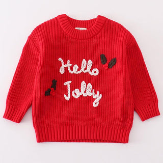 A red sweater with 'Hello Jolly' text and small embroidered holly on it, designed for toddlers.