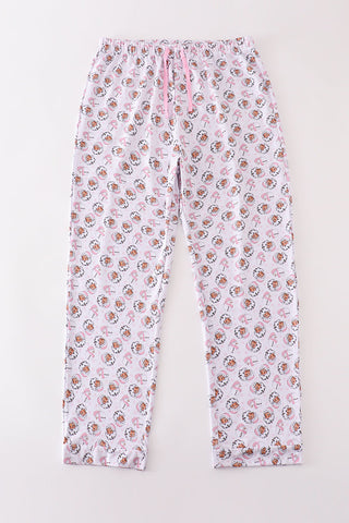 A pair of pink women's pajama pants with a Christmas Santa Claus print.