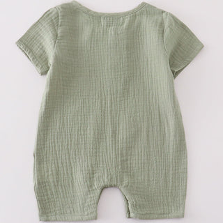 Green baby romper on a white background