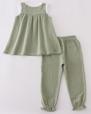 Green ribbed sleeveless top and pants set on a white background