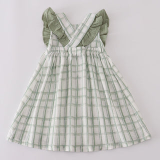 Green plaid dress with ruffled sleeves on a light gray background