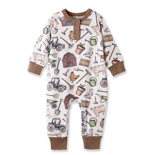 Baby onesie with farm-themed design on a white background