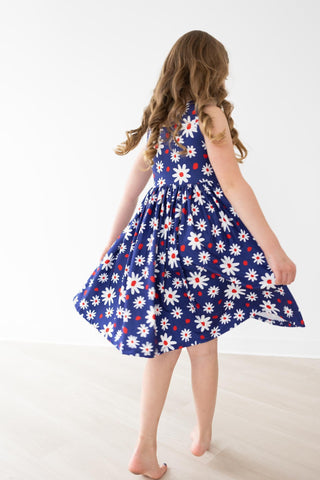 Young girl wearing a blue floral dress on a white background