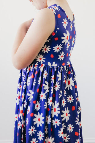 Girl wearing a blue dress with white floral pattern