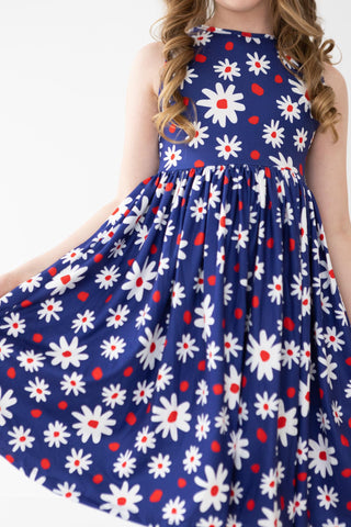 Navy blue dress with white floral patterns and red accents on a white background