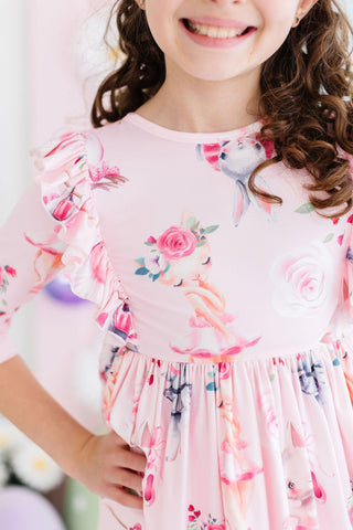 Child wearing a pink floral dress with a blurred background