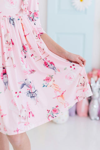 Pink floral dress withballerinas on a blurred background