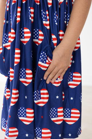 Navy blue dress with red, white, and blue heart-shaped American flag patterns.