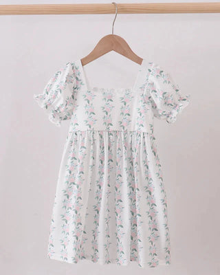 Floral dress on a hanger against a plain background