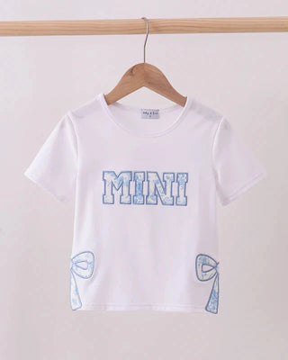 White t-shirt with blue text and graphics on a wooden hanger against a white background