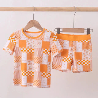 Children's outfit with patterned shirt and shorts on hangers against a white background