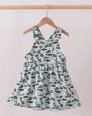 Children's dress with blue and green pattern on a hanger against a light background