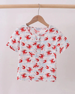 Children's shirt with red crab pattern on a hanger against a white background