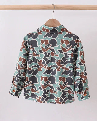 Long-sleeve shirt with a camouflage pattern on a hanger against a white background