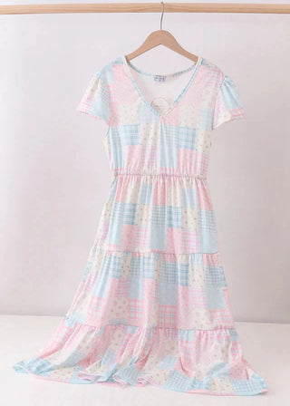 Pastel checkered dress on a hanger against a white background