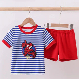 Children's outfit with striped shirt and red shorts on a wooden hanger against a light background