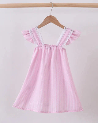 Pink striped dress with lace details on a hanger against a white background