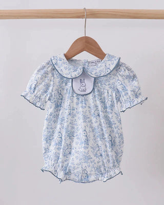 Floral baby romper with a collar on a wooden hanger against a white background