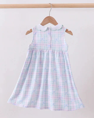 Pastel plaid dress on a hanger against a plain background
